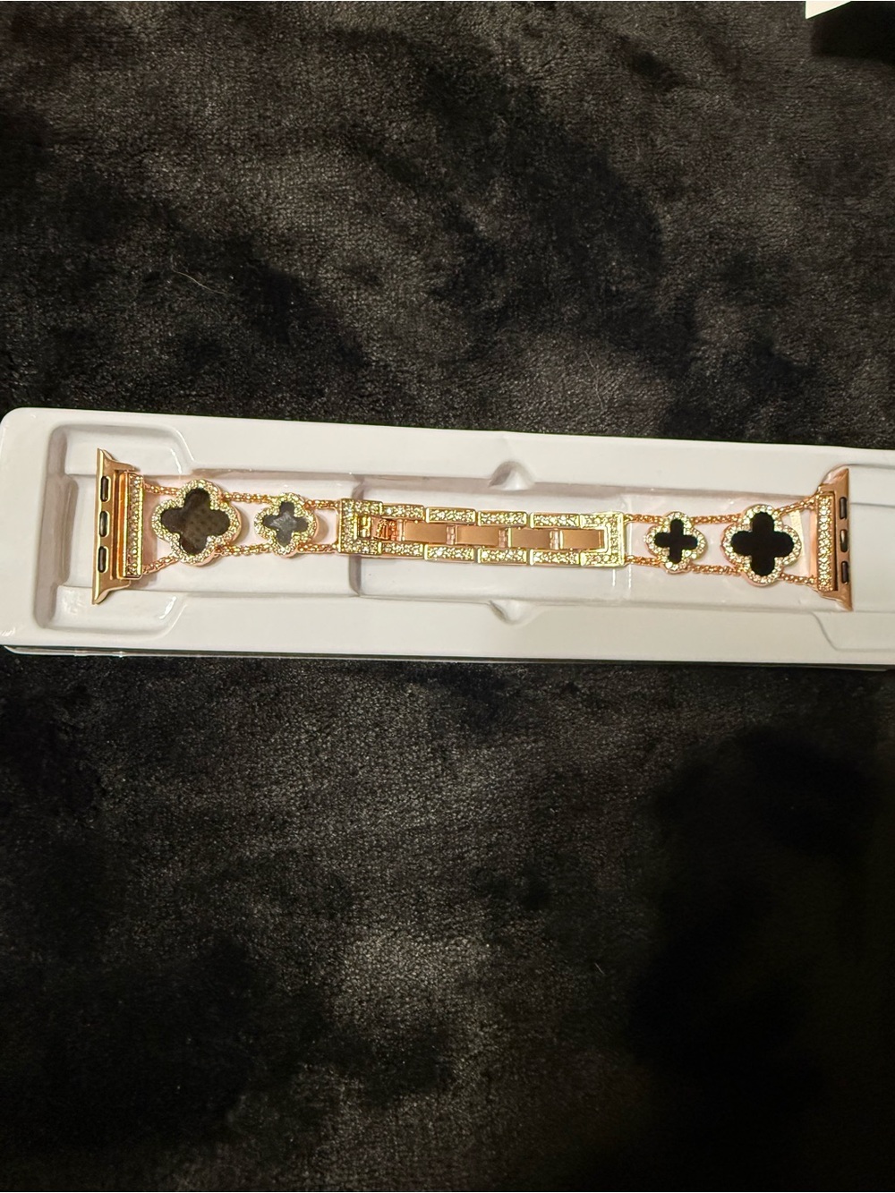 Gold black clover band compatible with Apple Watch for women.
